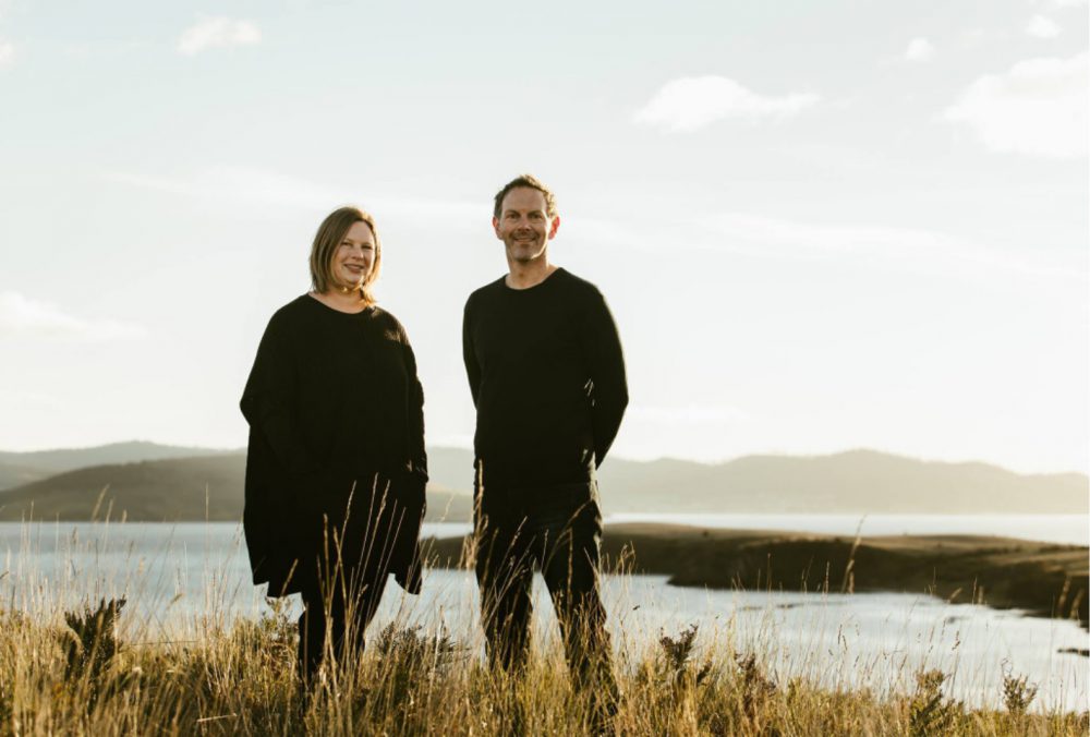 Karryn Dargie and Dean Baird, both of IN-TERIA, Interior Architects & Designers, stand on Arm End on the South Arm Peninsula. Photo by Adam Gibson.